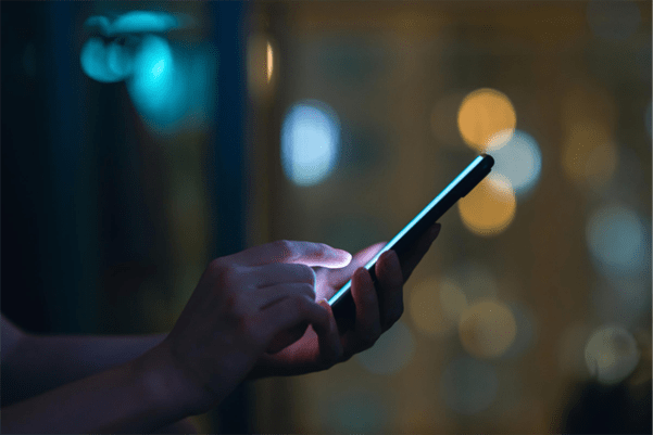 The view of someone's hand holding a smartphone