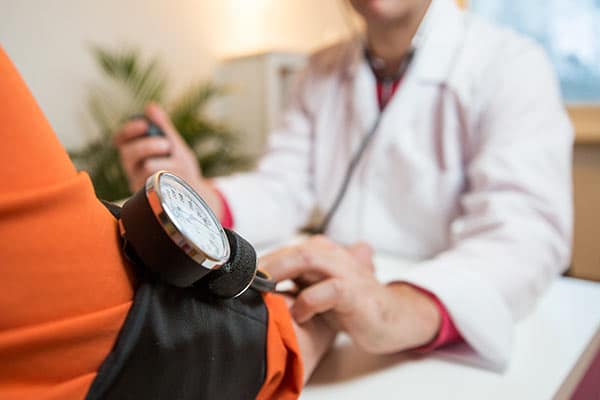A doctor taking a patient's blood pressure.