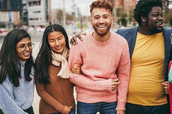 A group of generation Z adults walking and laughing together