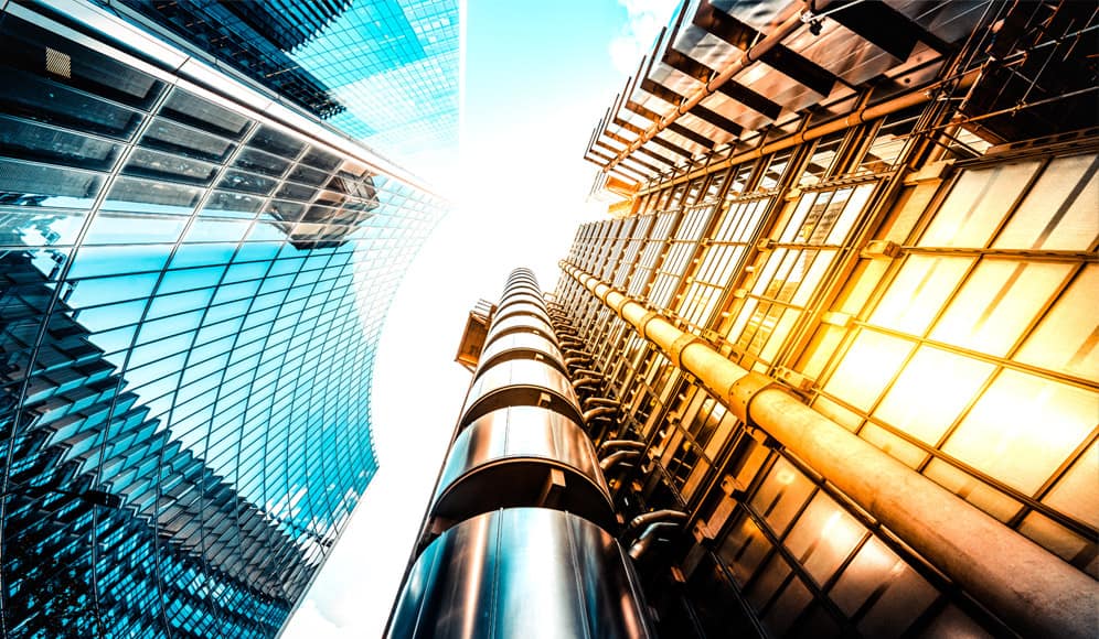 An image looking up at a few glass sky scrapers