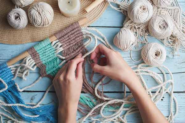 A small business owner working on knitted crafts.