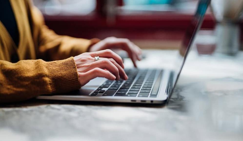 Woman typing on a laptop