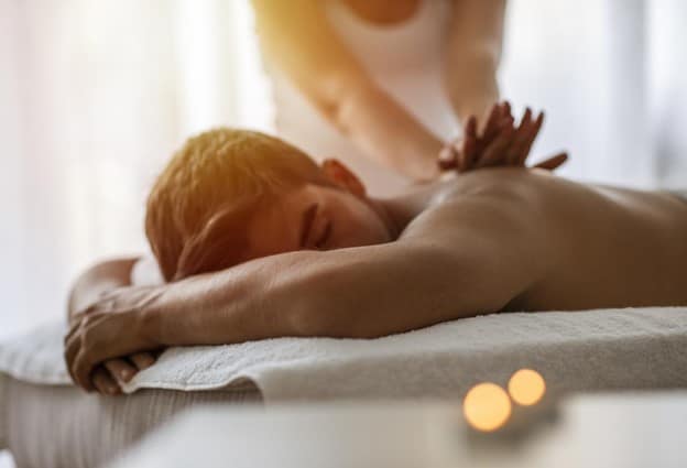 A massage therapist performing a deep tissue massage on a client.