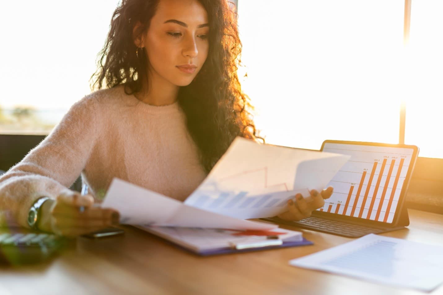 A freelance small business owner sat at her desk reviewing her business figures.