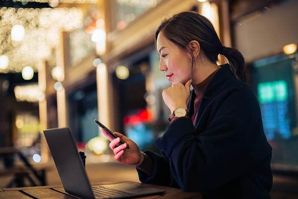 A freelancer using her phone to manage her business finances.