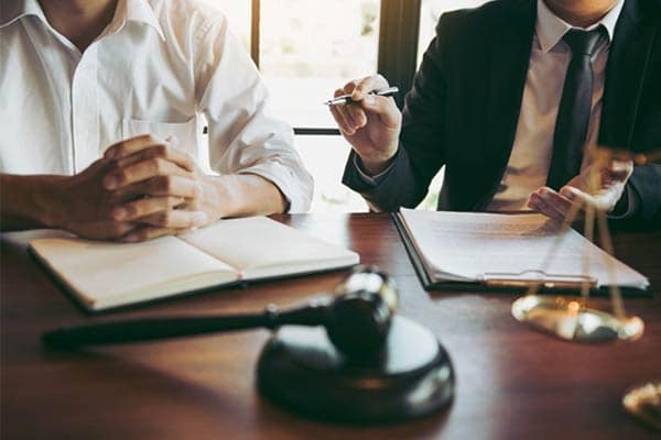 A lawyer discussing his client’s employment law case. 