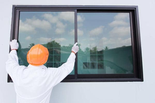 A professional glazier fitting a window.