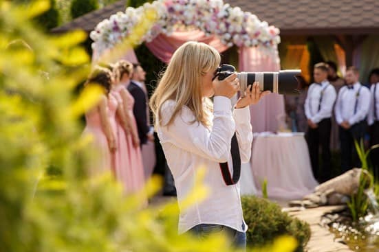 A professional wedding photographer shooting at a wedding