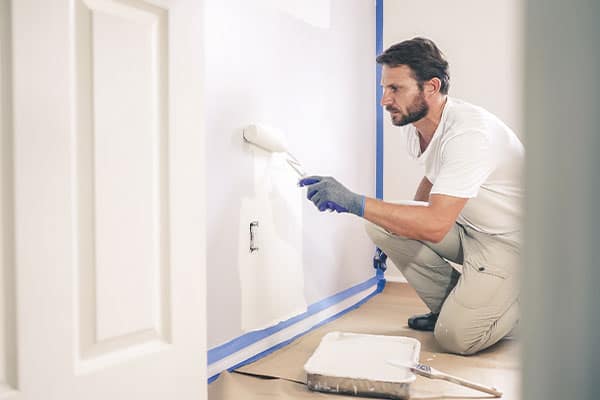 A painter and decorator working in a client's home.