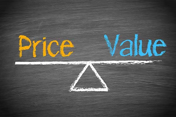 A graphic showing a chalk board with a drawing of a balancing scale holding price on one side and value on the other.