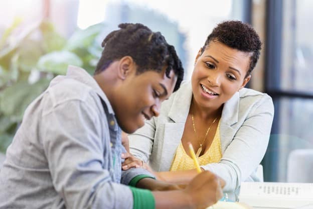A private tutor teaching a teenage student.