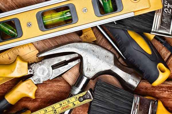 A set of tools on a wooden table. 