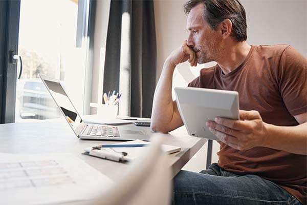 A worried business owner sat at his desk working on his finances.