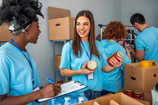 A group of employees volunteering for the day at a food bank.