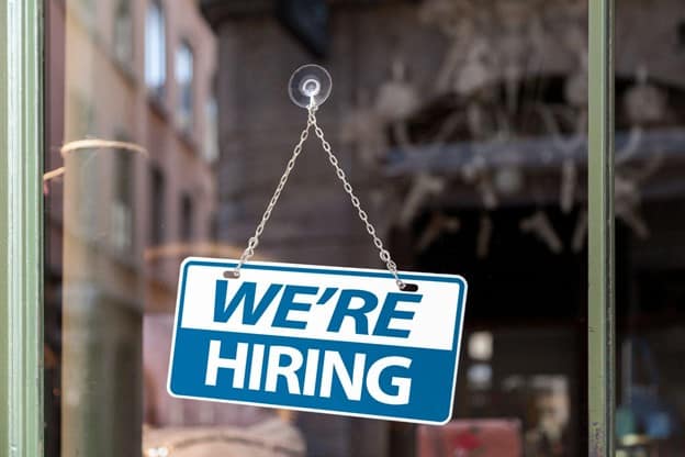 An estate agent sat at her desk on the phone to a client.