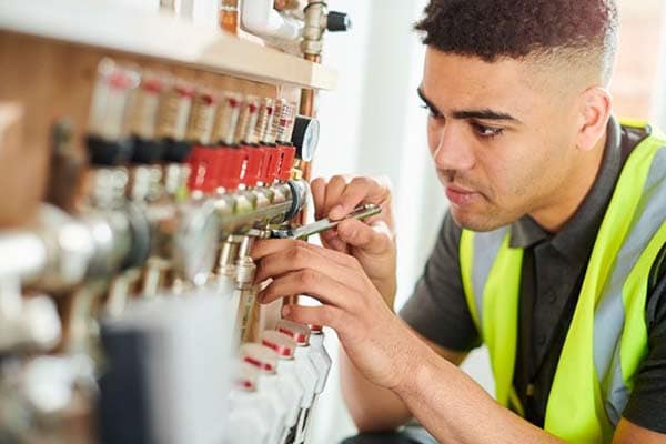 An electrician working on an underfloor heating system.