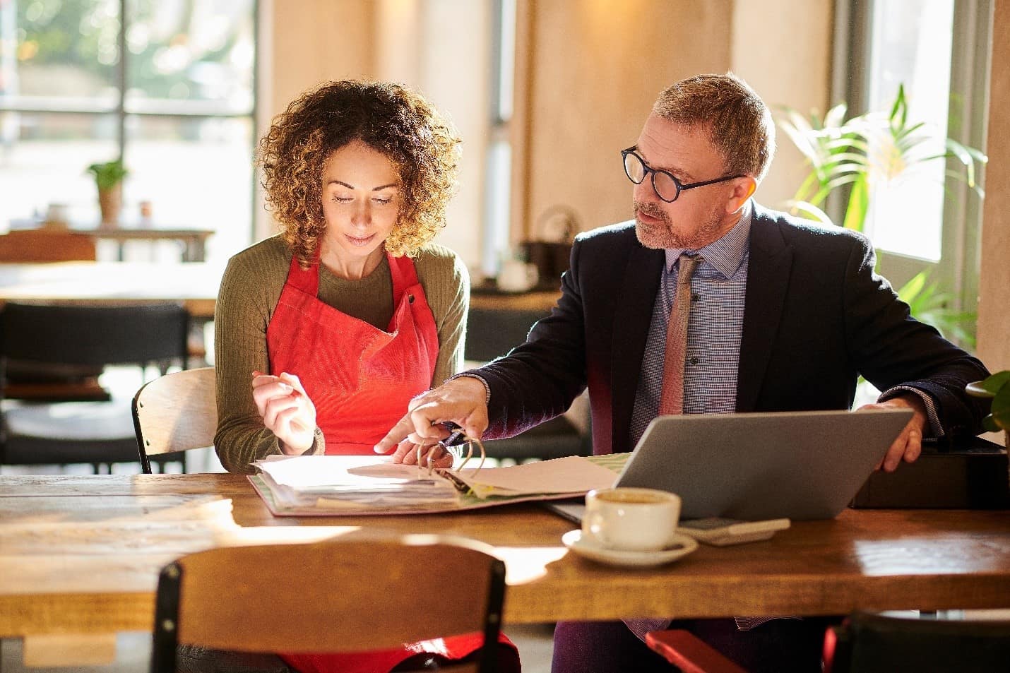 A business professional sat down with a customer, going through paperwork