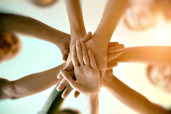 A group of hands together in a circle