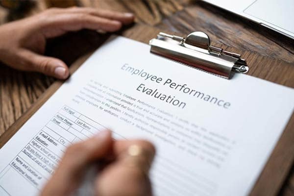 A manager completes an employee performance review form.