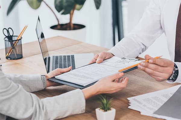 Why contractors need IR35 insurance - contractor and IR35 specialist reviewing contract.