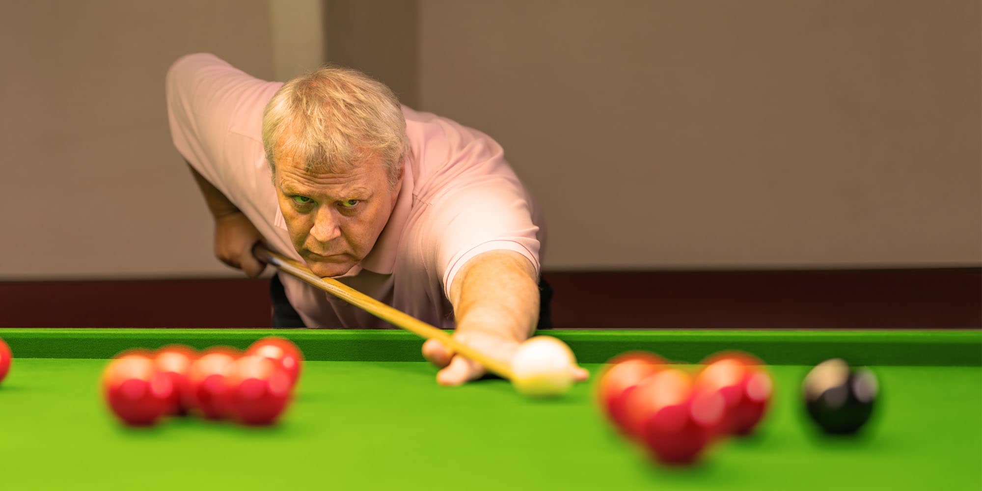 Man playing pool in community centre