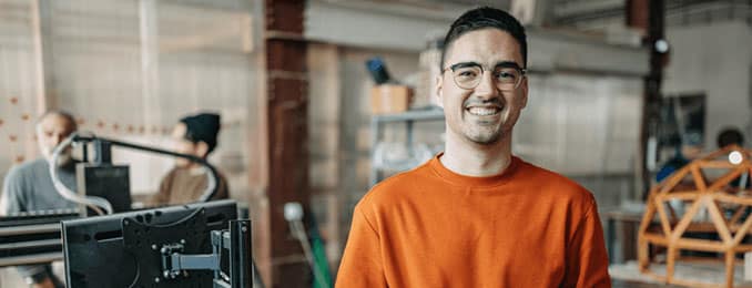 Man in orange jacket smiling