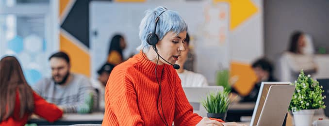 Woman wearing headset at a computer