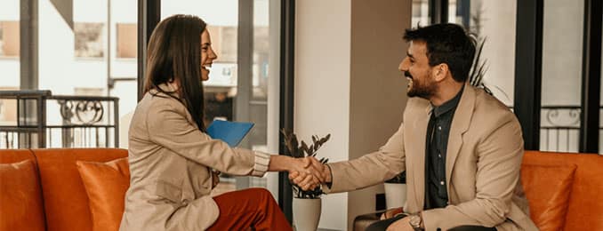 Sitting man and woman shaking hands