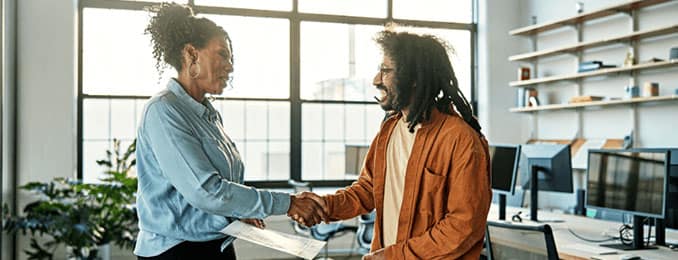 Man and woman shaking hands in an office