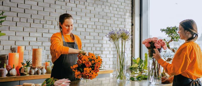 Self-employed florists arranging flowers in a boutique flower shop.