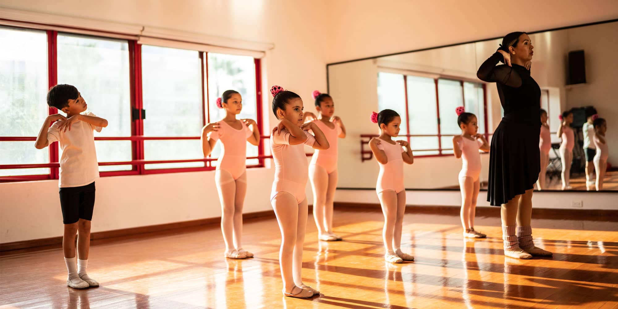 Dance teacher guiding a children’s dance class