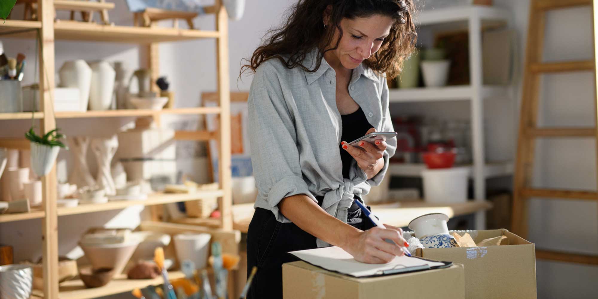 Woman packing items in a small business workspace