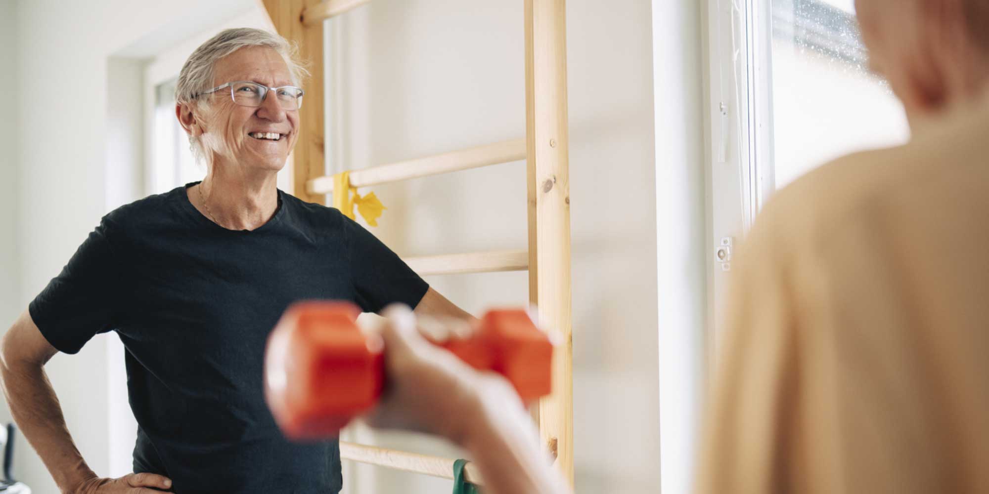 Elderly man receiving guidance from physiotherapist