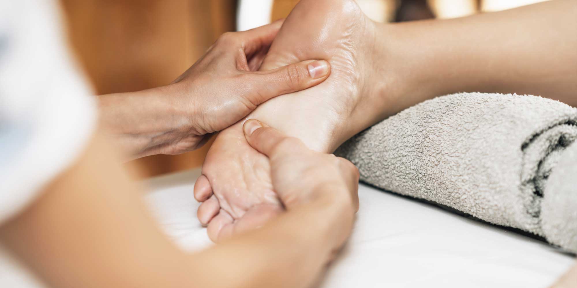 Hands performing a foot massage
