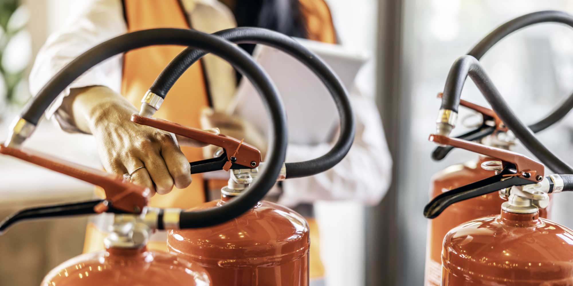 Security consultant inspecting fire extinguishers