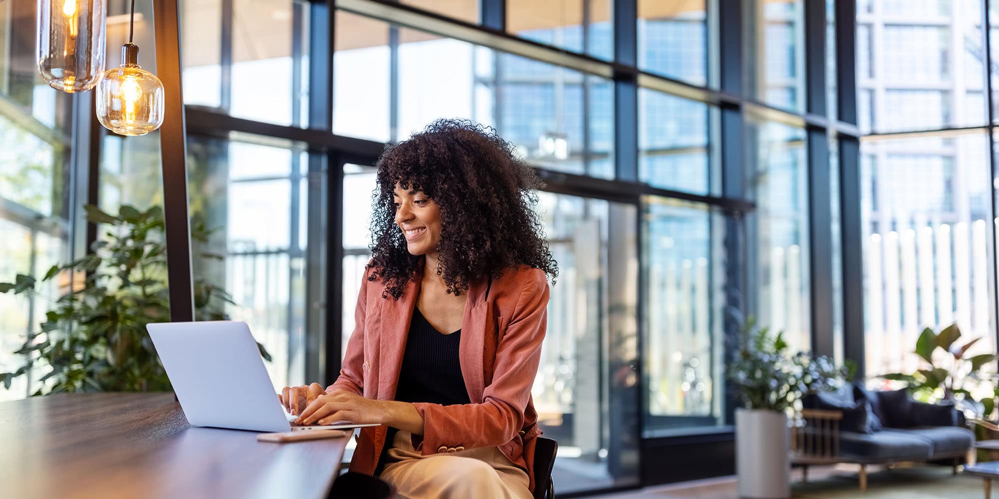 Woman working on a laptop in a contemporary office environment