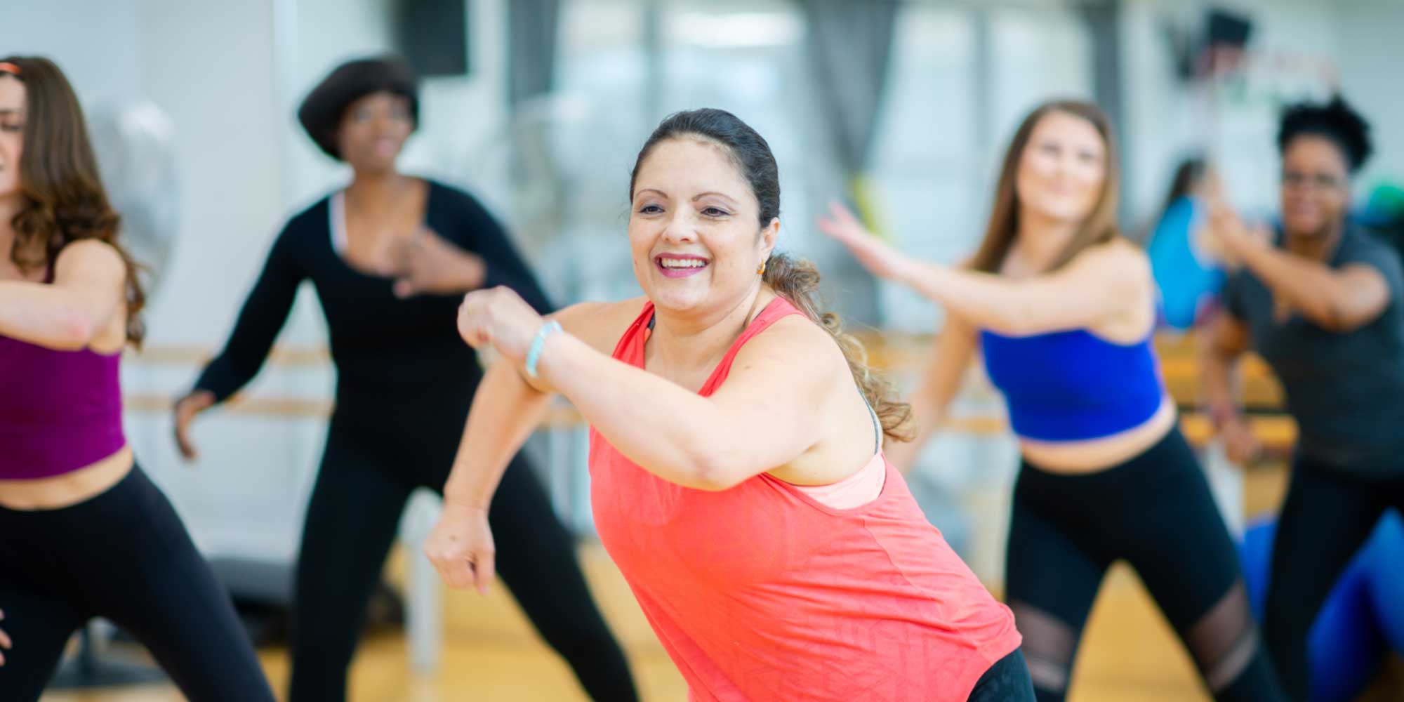 Fitness instructor leading a Zumba class