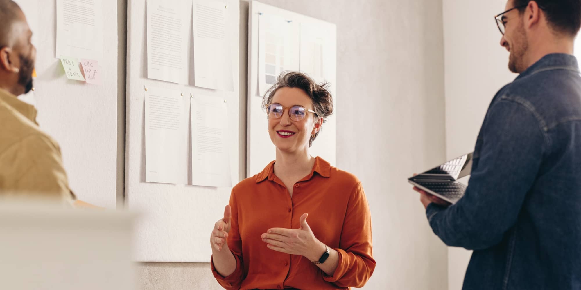 Group of people working in front of a white board
