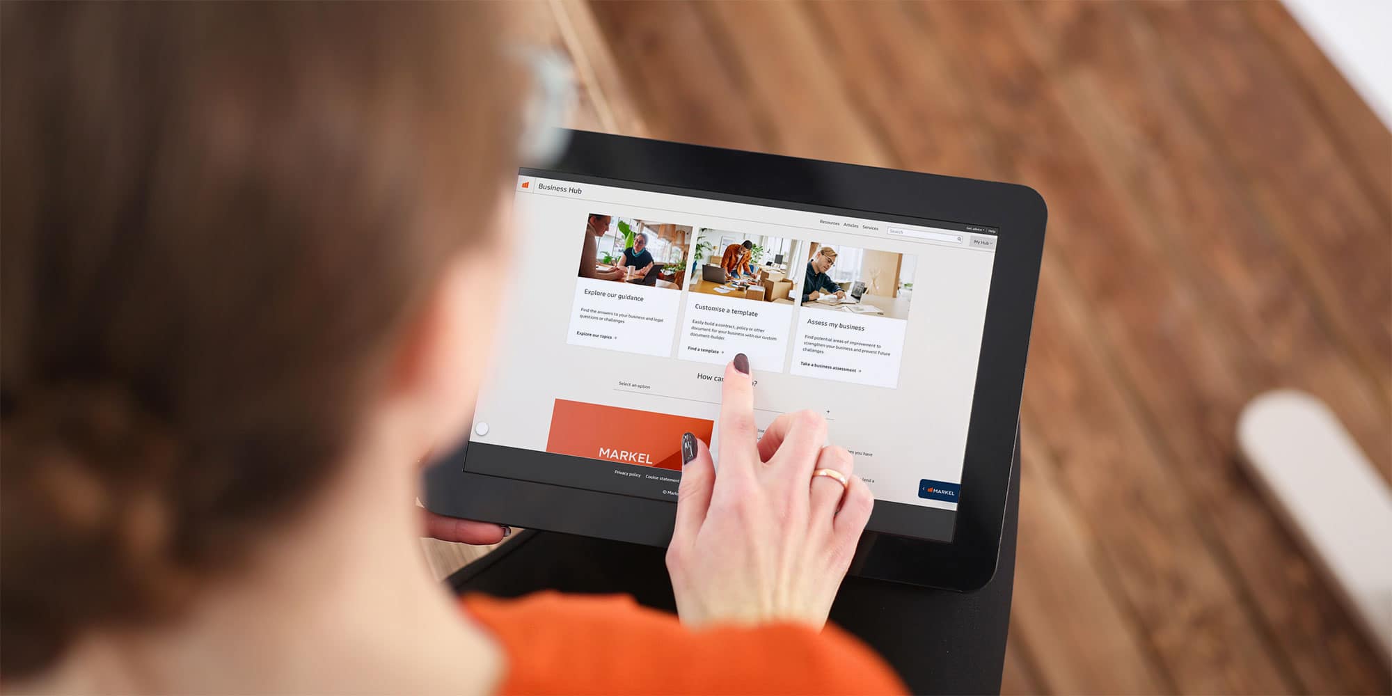 User exploring Markel's Business Hub on tablet with growth guides, customer training, and insurance service access.