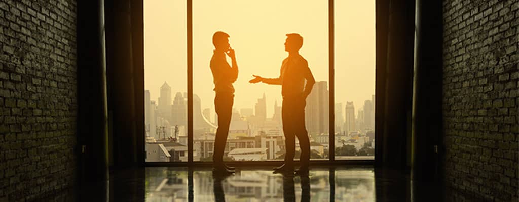 Two men overlooking city