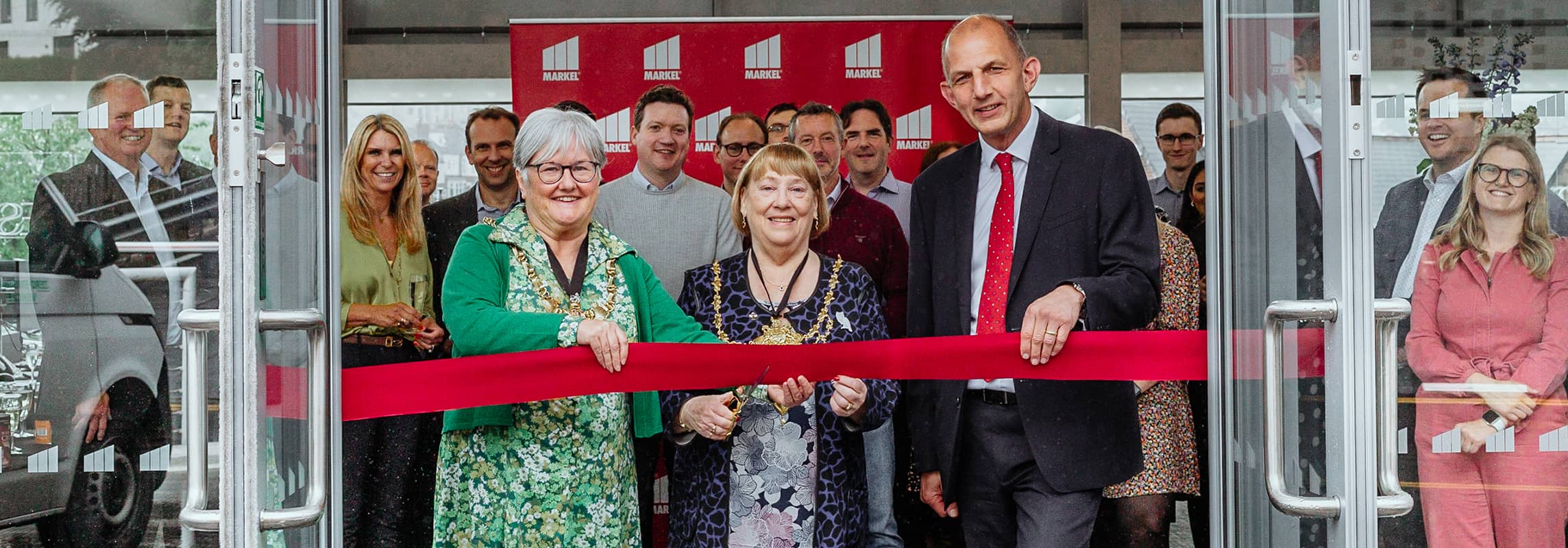 women cutting ribbon at office party in sheffield