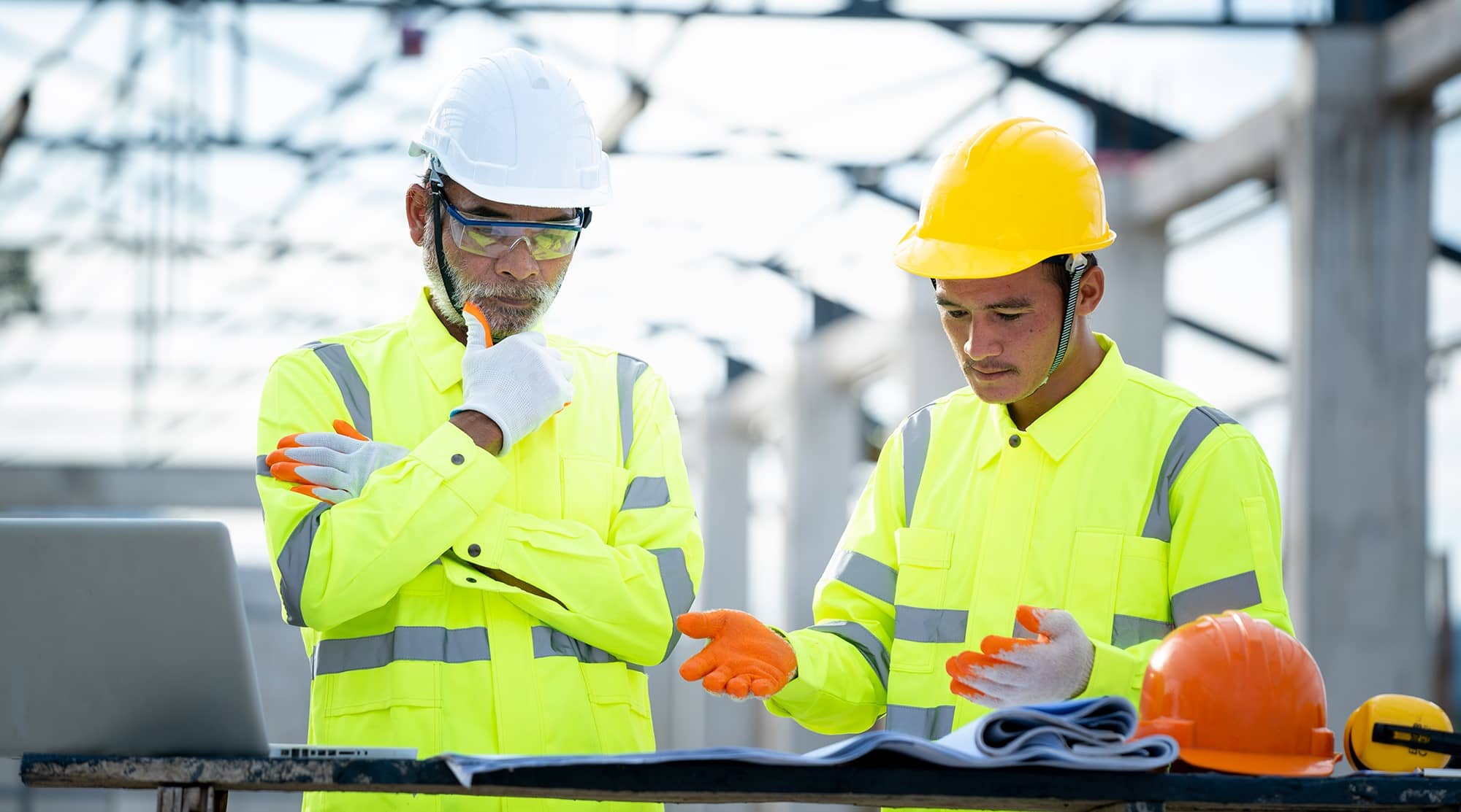 construction workers reviewing papers