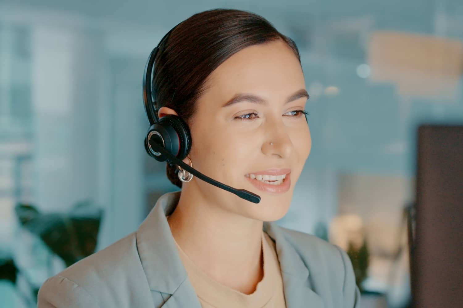 Woman sitting at desk with headset on