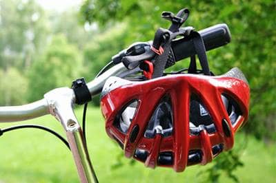 Bicycle helmet hanging on bicycle handlebar