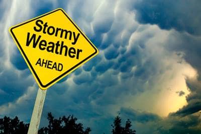 Stormy weather sign in front of rolling clouds