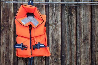 Life jacket hanging on fence