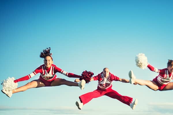 Cheerleaders red and white jumping