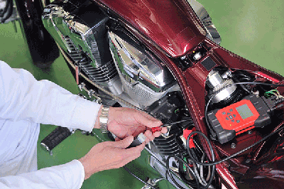 Man performing basic motorcycle maintenance
