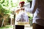 Man delivering food in pastic bag