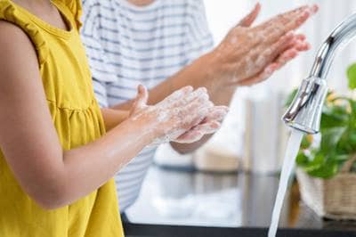 mom and daughter washing hands